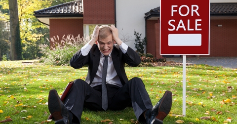 Irate man sitting on grass