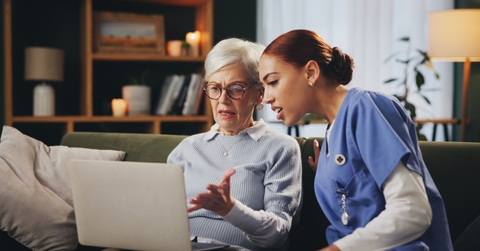 old woman with nurse on sofa