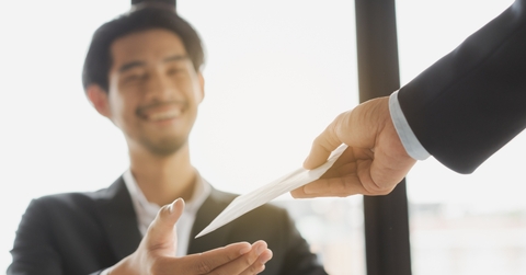 Happy office worker receiving extra money