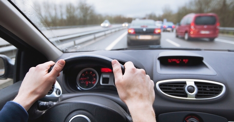 close up of hands on steering wheel