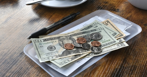 paying bill tab with money