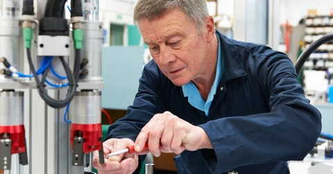 engineer working on machine in factory