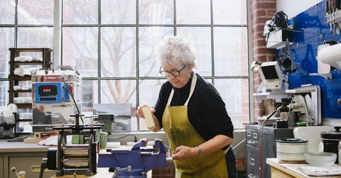 art jeweler working in studio