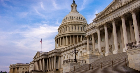 Low angle view of the east entrance to United States Capitol building in Washington DC with marble dome and stairs