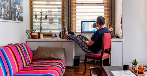 A man drinking coffee while working from home