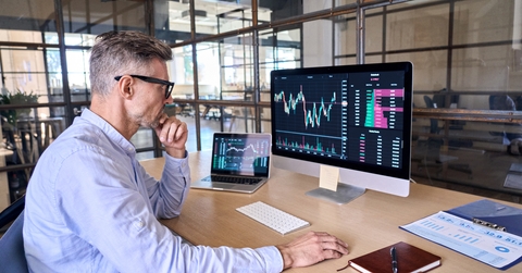 businessman analyzing stock market trading graphs report