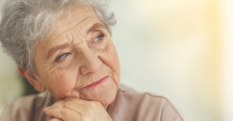 Close-up of an elderly woman with a reflective look on her face