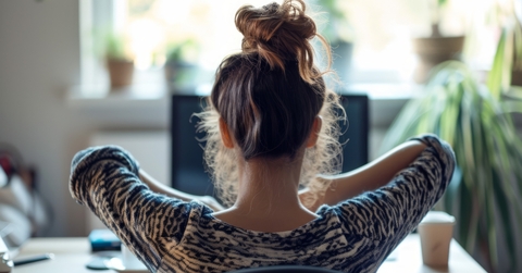 stretching at her desk