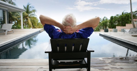 Senior man relaxing by the pool
