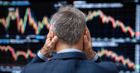 A distressed businessman observing volatile stock market trends
