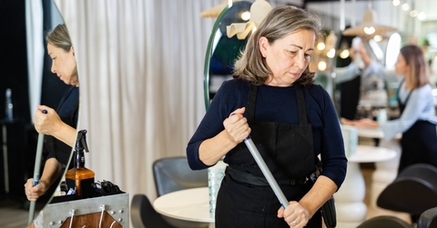 elderly female hairdresser cleaning