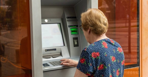 Senior woman is using an ATM
