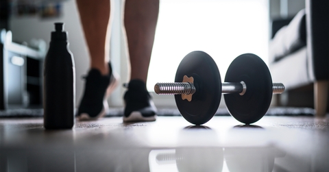 Man starting to exercise with dumbbell