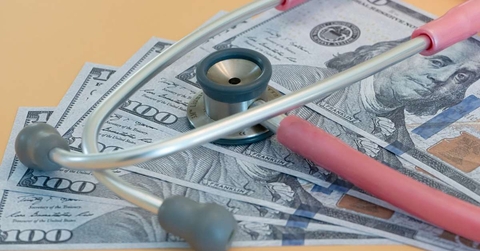 stethoscope laying on us bills