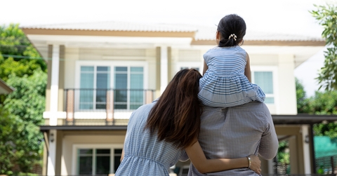 happy family in front of their new house