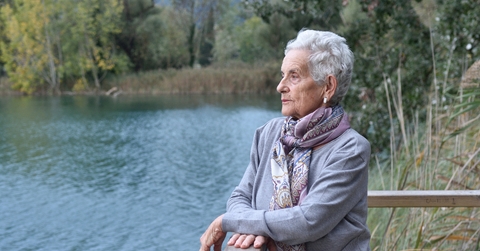 senior woman on the side of river