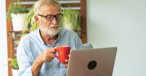 Boomer aged man working on a laptop