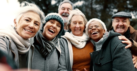 group of smiling retirees outdoors