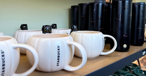 Starbucks mugs on a shelf