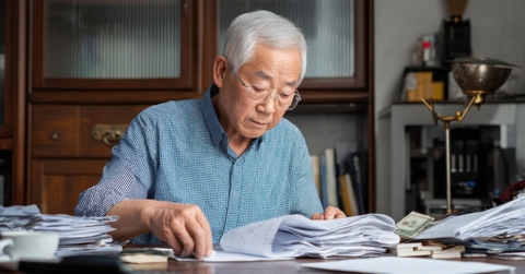 elderly man organizing documents