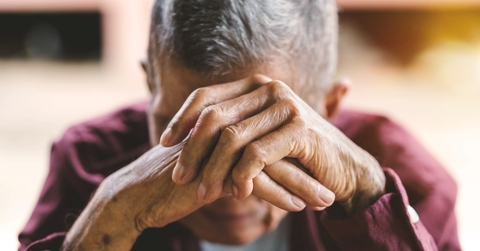 senior man covering his face with his hands