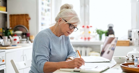 senior waman sitting at the table