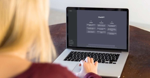 woman using chatgpt on laptop