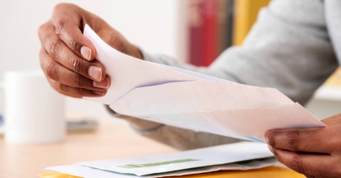 Hands holding check from envelope
