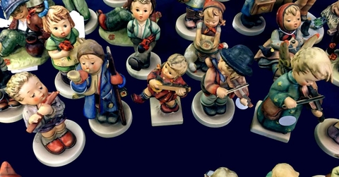 hummel porcelain figurines on a dark background