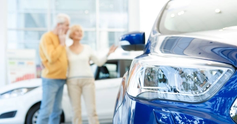 Senior couple choosing a new car to buy