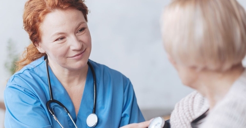medical worker taking woman's blood pressure