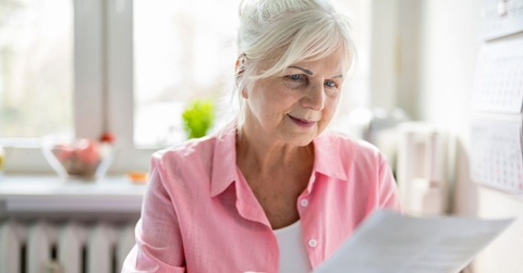 older woman reviewing papers