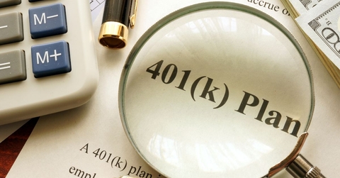 401(k) plan papers with magnifying glass