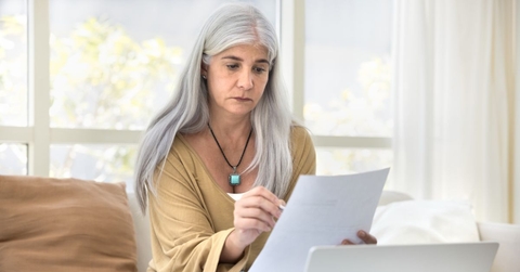 older woman reviewing papers