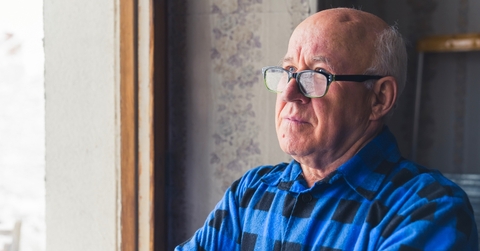 Senior man looking out the window