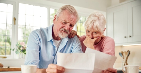 Concerned couple reviewing papers
