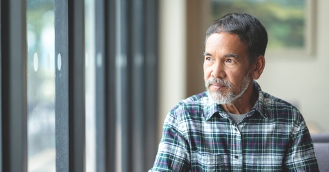 Mature man looking out window