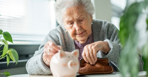 Elderly woman with a coin pouch and piggy bank