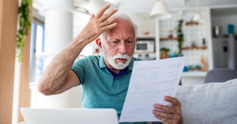 Senior shocked looking at papers