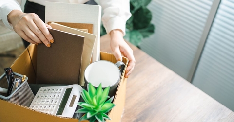 Woman with box of office supplies