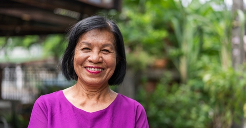 Woman in her late 60s looking at camera with a large smile